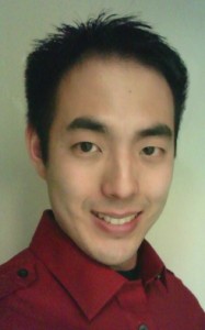 Photo of Brian Leaf and Asian American with short dark hair, medium light skin, wearing a red shirt and smiling.